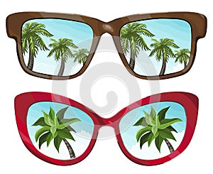 Sunglasses reflecting tropical palm and slue summer sky