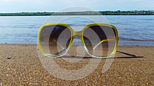 Sunglasses on the sand.