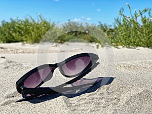 Sunglasses in sand on beach