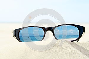 Sunglasses on sandy beach