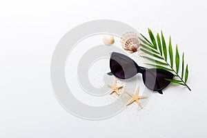 sunglasses with seashell lying on table background. Sunglasses on summer background. Top view flat lay with copy space