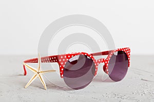 sunglasses with seashell lying on table background. Sunglasses on summer background. Top view flat lay with copy space