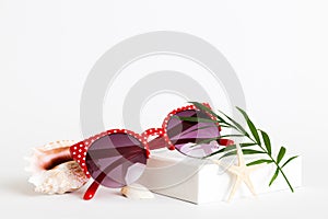 sunglasses with seashell lying on table background. Sunglasses on summer background. Top view flat lay with copy space