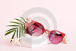 sunglasses with seashell lying on table background. Sunglasses on summer background. Top view flat lay with copy space