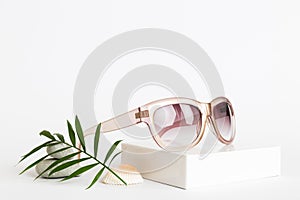 sunglasses with seashell lying on table background. Sunglasses on summer background. Top view flat lay with copy space