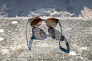 Sunglasses on a Seaside Beach Wall in Spring Sunshine