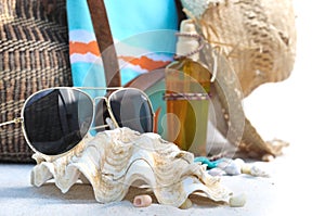 Sunglasses, shells and beach bag