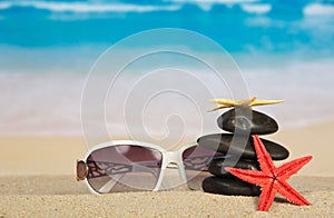 Sunglasses, starfishes and pebbles