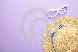 Sunglasses and striped retro haton purple background. Summer concept