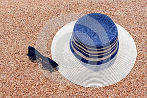 Sunglasses and sunhat on a tropical beach