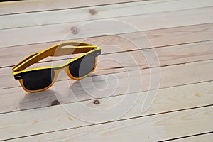 Sunglasses on the table with reflection sky