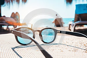 Sunglasses of a tourist on a deckchair at a beach