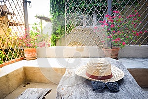 Sunglasses with vintage straw hat fasion on wooden table photo