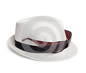 Sunglasses and a white summer hat on background