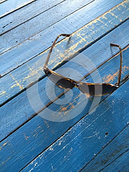 A sunglasses on a wooden table