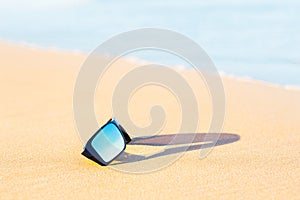 Sunglasses on yellow sand beach