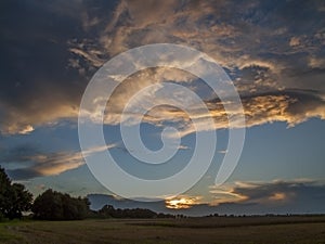 Sunglow reflecting on heavy clouds.