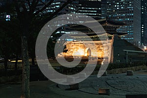 Sungnyemun Gate or Namdaemun Gate and Fortress Wall during winter night at Jung-gu , Seoul South Korea : 6 February 2023