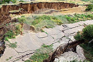 The sunk asphalt road after a landslide, natural disaster landslide of soil.