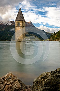 Sunk church in lake with mountain panorama