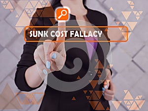 SUNK COST FALLACY inscription on the screen. Businessman hands holding black smart phone