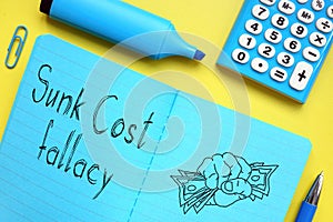 Sunk cost fallacy is shown on the conceptual photo using the text