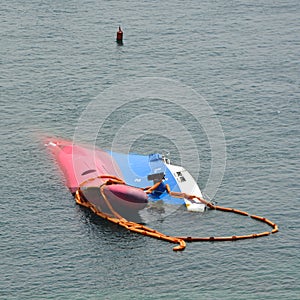 A sunken ship with just its bow visible above the waves