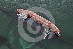 A sunken ship, a sunken tanker near the beach, a wrecked ship on the water. Top view