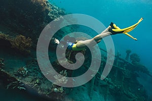 A sunken shipwreck in the mediterranean sea with a scuba diver