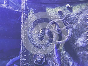 Sunken submarine. the faucet and lid were covered with rust and moss from long exposure to water. the metal sank due to the wreck