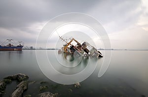 A sunken wreck rusting into the sea