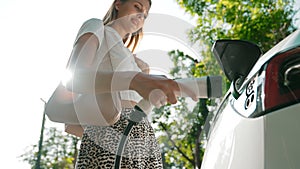 Sunlight backlit brighten young woman travel with EV car innards