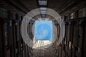 Sunlight and blue sky seen from a square inner courtyard of a high rise communist housing building in the Belgrade suburb