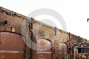 Sunlight on a brick wall of an industrial warehouse building, urban architecture