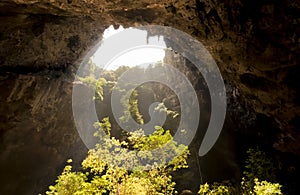 Sunlight through a cave hole in Thailand.