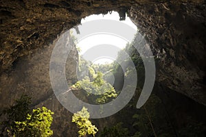 Sunlight through a cave hole in Thailand.