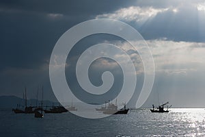 Sunlight through the clouds, a fishing boat,