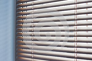 Sunlight coming through venetian blinds by the window . photo