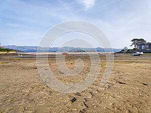 Sunlight creeps across Borth-y-Gest harbour at low tide