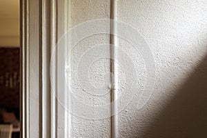 Sunlight falling on the room wall through a transom window photo