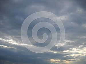 Sunlight finding its way through rainy cloudscape