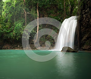 Sunlight in jungle rainforest with scenic waterfall