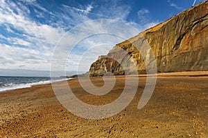 Sunlight lights the copper cliffs at Whale Chine in The isle of wight, England