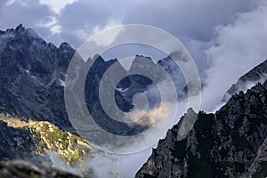 Sunlight on mountains in clouds