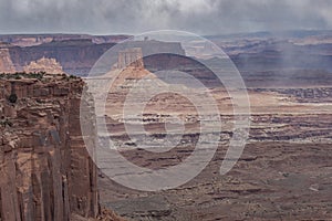 Sunlight and rainclouds over Buck Canyon, Canyonlands National Park, Utah