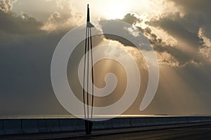 Sunlight rays bursting through the clouds on to the sea below