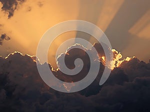 Sunlight Rays Piercing Through Dramatic Evening Clouds