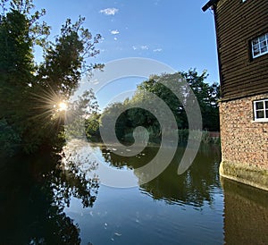 Sunlight reflected on the river, Houghton Mill, Cambridgeshire, UK.