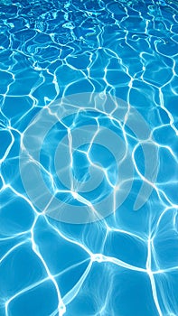 Sunlight reflecting on a clear blue water surface creating a caustic light pattern background