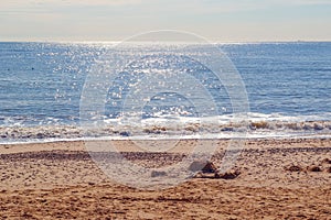 Sunlight reflecting on sparkling blue sea at Southwold beach in the UK